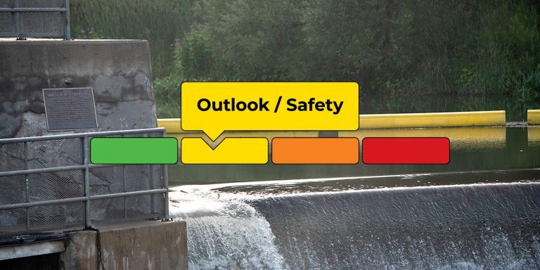 Flood Outlook / Safety condition graphic with an image of water flowing over Corbett's Dam in the background