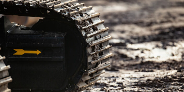 Excavator on muddy trail